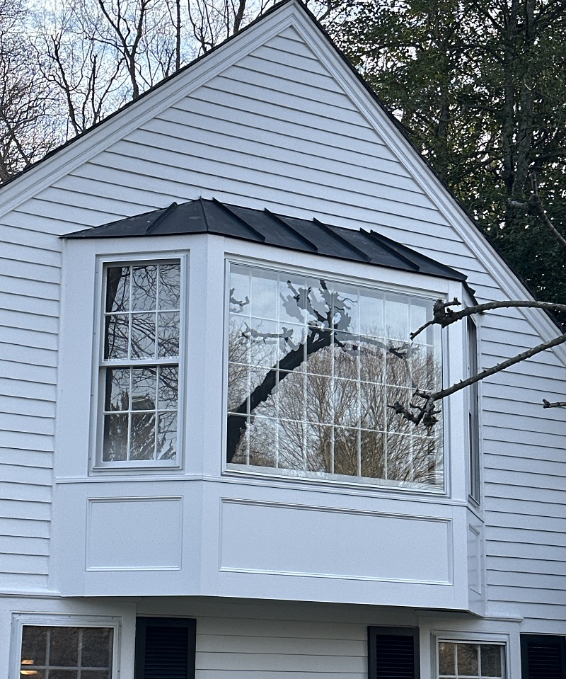 Old bay window in Norwalk,CT with a metal roof